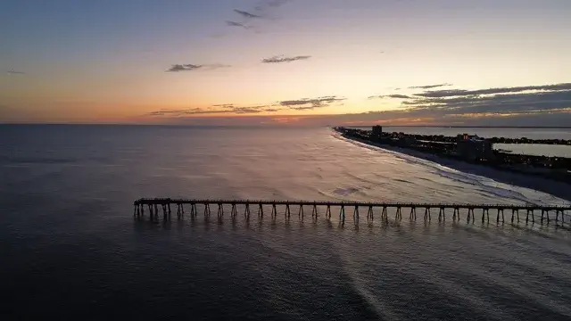 The Gulf Pier at sunset in Pensacola Beach, Florida.